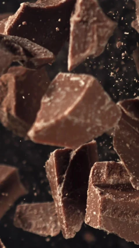 Pieces of chocolate fly up and fall down. Filmed on a high-speed camera at 1000 Stock Footage 335375004