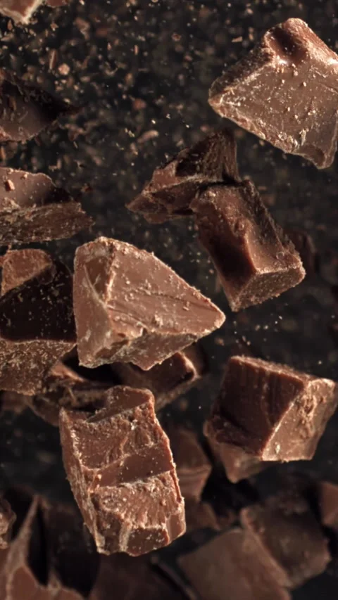 Pieces of chocolate fly up and fall down. Filmed on a high-speed camera at 1000 Stock Footage 335376673