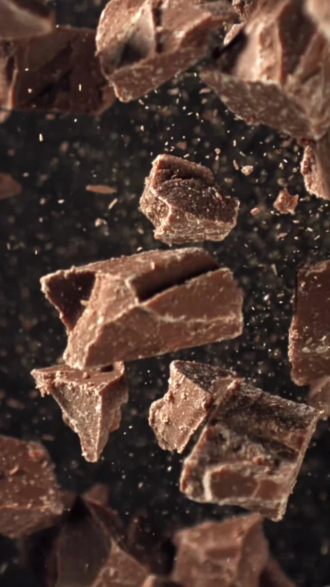 Pieces of chocolate fly up and fall down. Filmed on a high-speed camera at 1000 Stock Footage 335377854