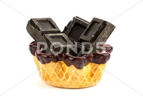 Pieces of chocolate inside a porcelain cup isolated on white background Stock Photos