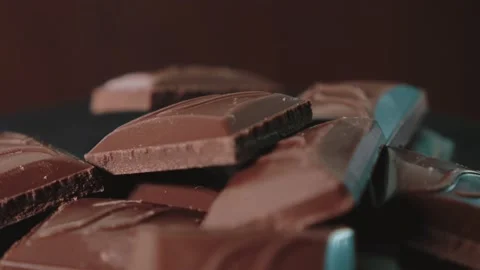 Pieces of chocolate lie on a rotating platform Stock Footage 167213479