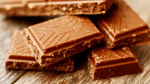 Pieces of chocolate on table. Eating sweets on dessert at home or cafe. Stock Footage 116826513
