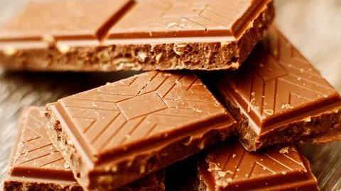 Pieces of chocolate on table. Eating sweets on dessert at home or cafe. Stock Footage 116826636