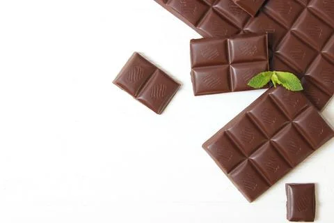 Pieces of chocolate on the table. Stock Photos