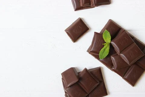Pieces of chocolate on the table. Stock Photos