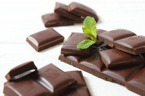 Pieces of chocolate on the table. Stock Photos