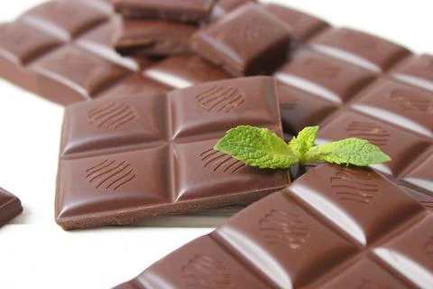 Pieces of chocolate on the table. Stock Photos