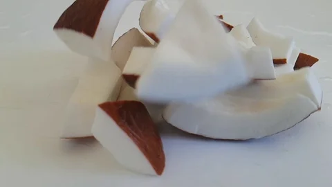 Pieces of coconut on white background, slow-motion shooting falling Video stock 87827798