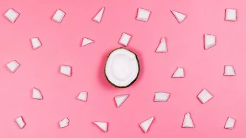 Pieces of coconuts on a pink table. Stop the motion. 4k Stock-Footage 88398791