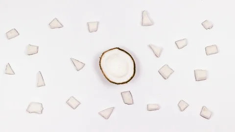 Pieces of coconuts on a white table. Background. Stop the motion. 4k 動画素材 88398847