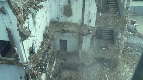 Pieces of concrete and bricks are falling in slow motion from ruined building Vídeo Stock 63790233