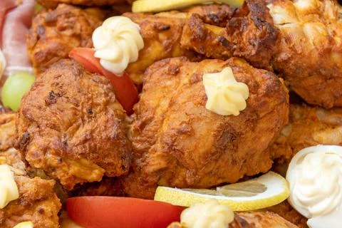 Pieces of cooked chicken in a dish Stock Photos