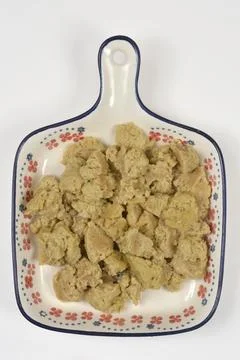 Pieces of cooked seitan on a patterned ceramic plate Stock Photos
