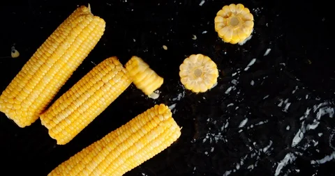 Pieces of corn fall on the water splashes. Stock Footage 127538518