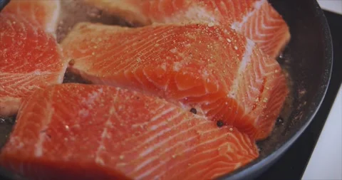Pieces of delicious fish cooked in the kitchen. Fillet of red fish is fried in a Stock Footage 145771264