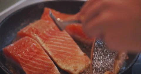 Pieces of delicious fish cooked in the kitchen. Shot of cooking big beautiful Stock Footage 145772370