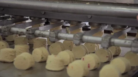 Pieces of dough are formed using automatic device in workshop of bakery indoor. Видео 83027485