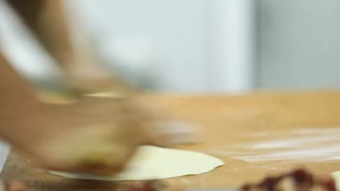 Pieces of dough are rolled out flat Stock Footage 243630053
