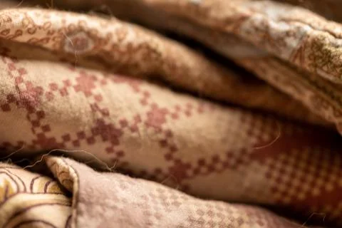 Pieces of fabric with different patterns, stacked. Close-up, selective focus Stock Photos