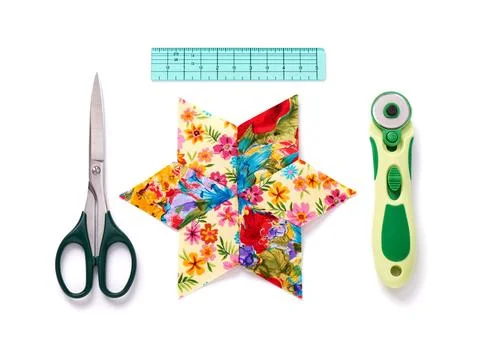 Pieces of fabric patchwork stitched in the shape of a star surrounded by tool Fotos de archivo