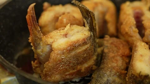 Pieces of fish being fried to a golden brown crust Stock Footage 344843943