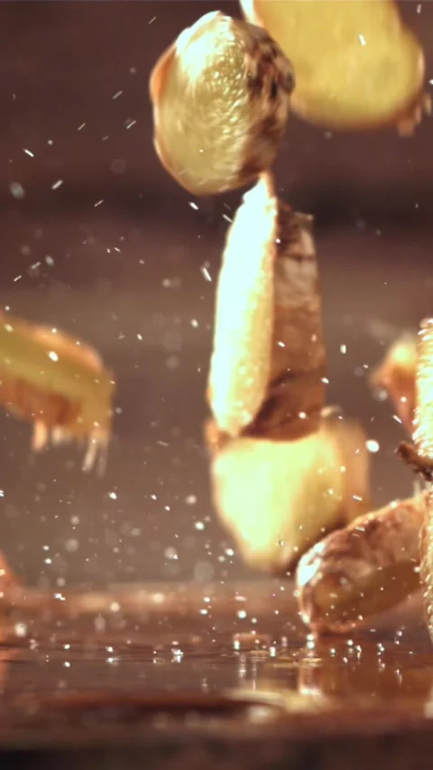 Pieces of fresh ginger fall on the table. Filmed on a high-speed camera at 1000 Stock Footage 335314705