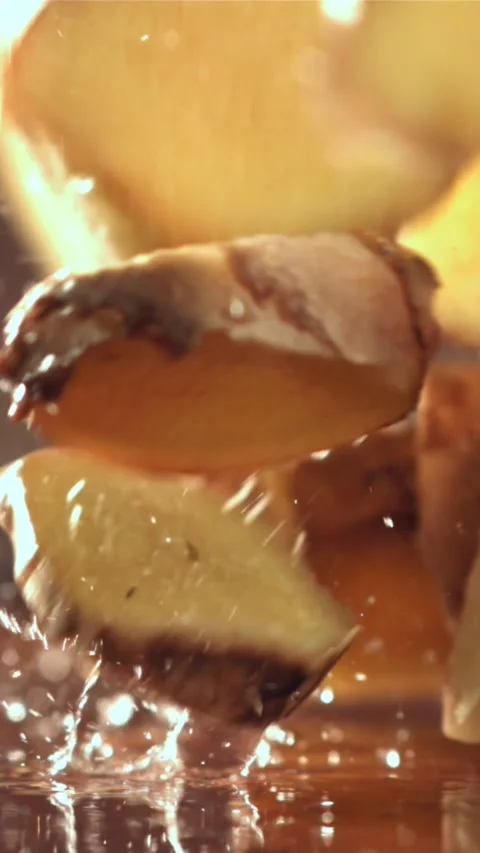 Pieces of fresh ginger fall on the table. Filmed on a high-speed camera at 1000 Stock Footage 335315289