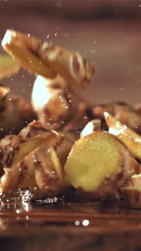 Pieces of fresh ginger fall on the table. Filmed on a high-speed camera at 1000 Stock Footage 335316501