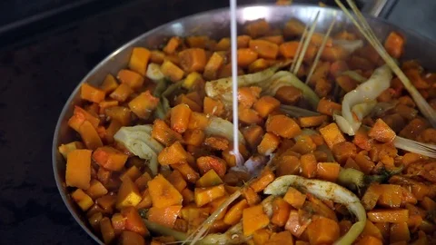 Pieces fresh vegetables fried in a pan and pour milk on top. Stock Footage 88944240