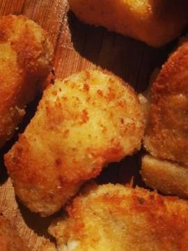 Pieces of fried breaded chicken or fish close up Stock Photos