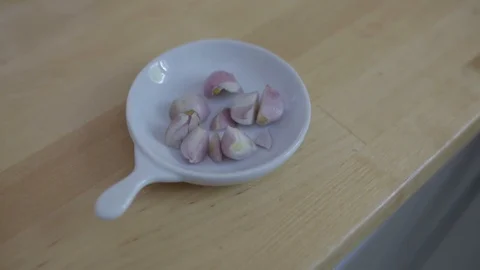 Pieces of Garlic in a small Plate Stock Footage 99962088