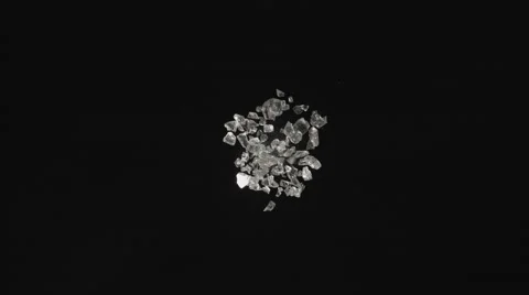 Pieces of glass fly after being exploded. 4K 30fps. Slow Motion. Stock Footage