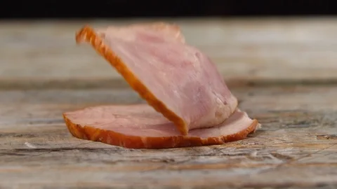 Pieces of ham fall on top of the Board in slow motion Stock Footage 113423830