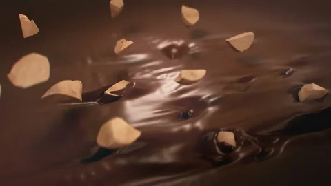 Pieces of Hazelnuts Falling Into Liquid Chocolate in 4K Super slow motion 動画素材 141982931