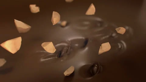 Pieces of Hazelnuts Falling Into Liquid Chocolate in 4K Super slow motion Stock-Footage 141982949