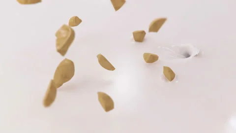 Pieces of Hazelnuts Falling Into Milk in 4K Super slow motion Stock Footage 141979711