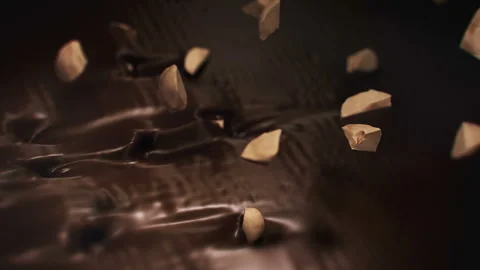 Pieces of Hazelnuts Splashing Into Liquid Dark Chocolate in 4K Super slow motion Stock Footage 141982685