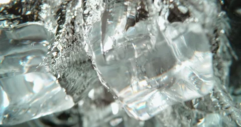 Pieces of ice cube falling in water Stock Footage 311826997