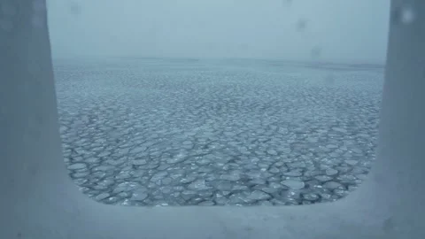 Pieces of ice on waves. View from window of vessel. Puzzle of ice pieces. Small Stock Footage 257820665