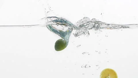 Pieces of Lime and Lemon falling into water Stock-Footage 240779814