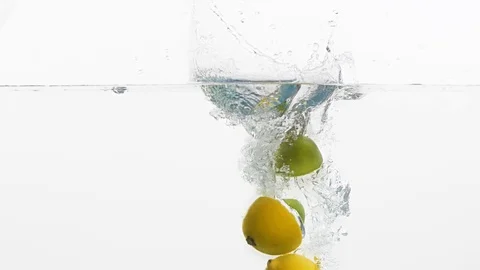 Pieces of lime and lemon in water Stock Footage 99724696