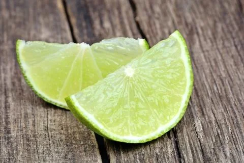 Pieces of lime on old table Stock Photos