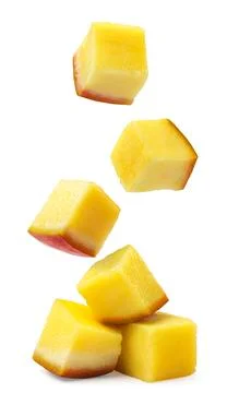 Pieces of mango fall on a pile on a white background. Isolated Stock Photos