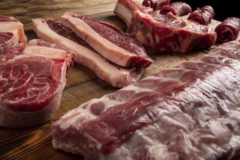 Pieces of meat of different types on the board. beef and pork Stock Photos