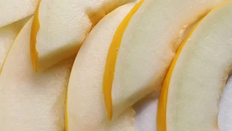 Pieces melon with peel, rotation in circle. slices of fresh ripe juicy melon Stock Footage 283726544
