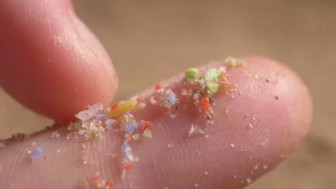 Pieces of microplastic on the finger. primary and secondary microplastics. small Stock Footage