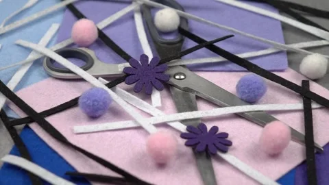 Pieces of multi-colored felt textile, felt decorative elements and scissors Video stock 258300818
