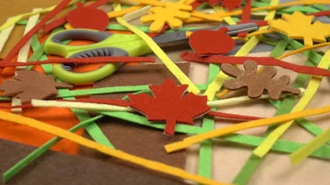 Pieces of multi-colored felt textile, felt decorative elements and scissors Video stock 258301072