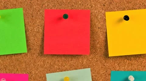 Pieces of note paper on a cork bulletin board Stock Footage 20544143