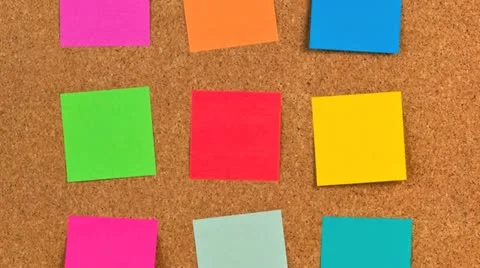 Pieces of note paper on a cork bulletin board Stock Footage 21302070